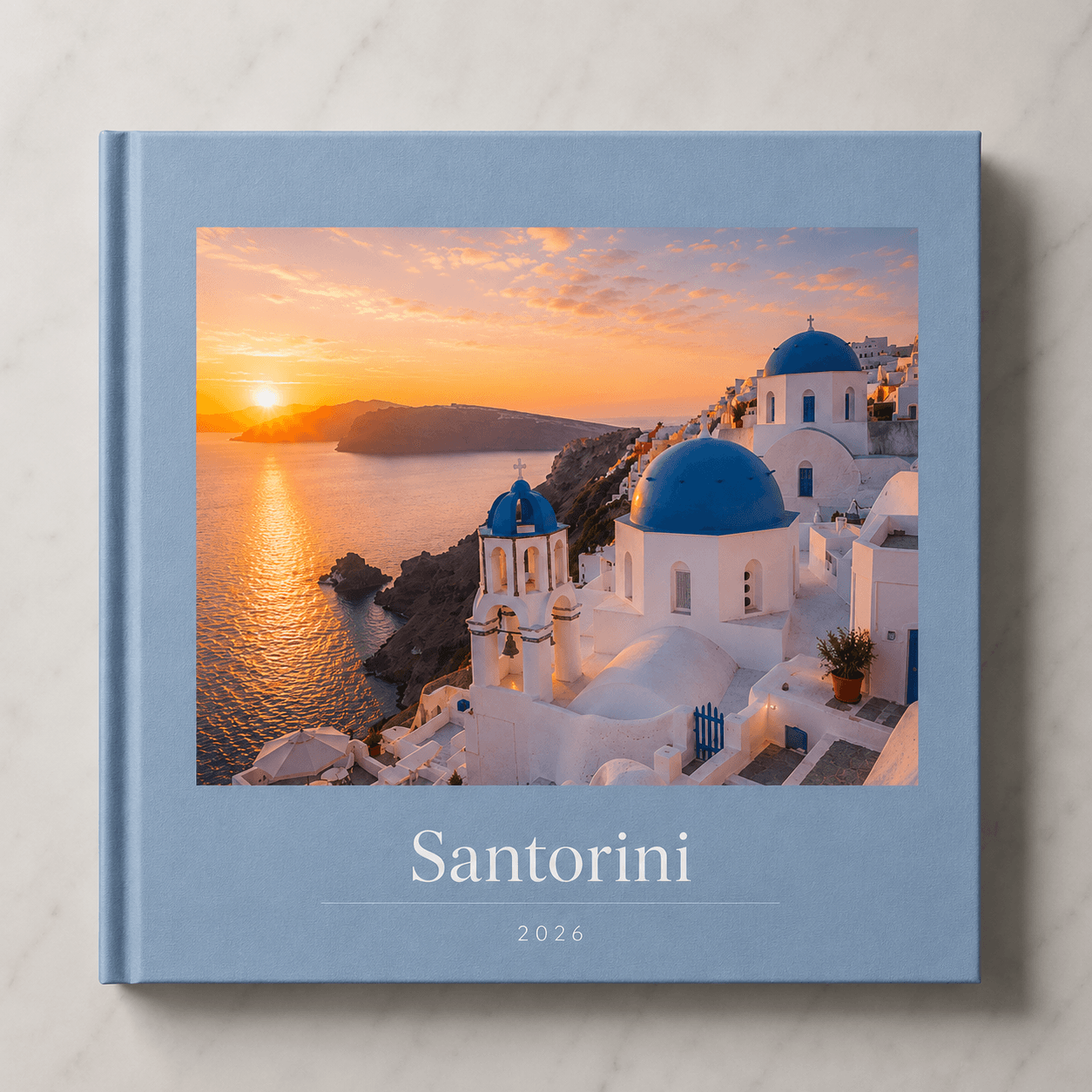 Santorini travel photobook by Memtach — hardcover with Oia's blue domes on the front